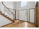 Impressive foyer with wood flooring, a grand staircase, and a bright, welcoming entrance at 12307 Pebblepointe Pass, Carmel, IN 46033