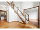 Spacious foyer featuring hardwood floors, a staircase with white spindles, and access to other rooms at 12307 Pebblepointe Pass, Carmel, IN 46033