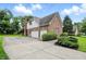 Spacious two-car garage with an extended driveway and manicured landscaping, perfect for ample parking at 12307 Pebblepointe Pass, Carmel, IN 46033