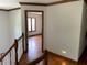 Hallway from the top of the stairs featuring hardwood floors and wood trim at 12307 Pebblepointe Pass, Carmel, IN 46033