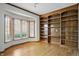 Spacious office featuring a bay window and custom wood bookshelves, perfect for a work-from-home setup at 12307 Pebblepointe Pass, Carmel, IN 46033