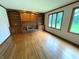 Inviting living room with hardwood floors, built-in bookshelves, fireplace, and many windows at 12307 Pebblepointe Pass, Carmel, IN 46033