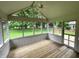 Bright screened patio with wooden floors and open views, perfect for enjoying the outdoors in comfort at 12307 Pebblepointe Pass, Carmel, IN 46033