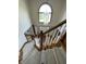 Elegant staircase with carpeted steps leads down to a light-filled foyer with chandelier at 12307 Pebblepointe Pass, Carmel, IN 46033