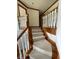 Carpeted stairs with white railing and wood trim provide a smooth transition between levels in this home at 12307 Pebblepointe Pass, Carmel, IN 46033