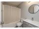 This full bathroom features a shower over tub, modern vanity, and round mirror at 15405 Fawn Meadow Dr, Noblesville, IN 46060