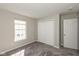 This bedroom has neutral carpeting, a window with blinds and a closet with folding doors at 15405 Fawn Meadow Dr, Noblesville, IN 46060