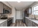 Charming kitchen with stainless appliances, gray cabinets, and vinyl flooring at 15405 Fawn Meadow Dr, Noblesville, IN 46060