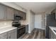 Kitchen featuring stainless appliances, gray cabinets, and vinyl flooring at 15405 Fawn Meadow Dr, Noblesville, IN 46060