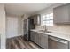 Well-lit kitchen with stainless steel appliances, gray cabinets, and modern backsplash at 15405 Fawn Meadow Dr, Noblesville, IN 46060