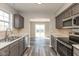 Kitchen with stainless appliances, gray cabinets, and sliding door leading to backyard at 15405 Fawn Meadow Dr, Noblesville, IN 46060
