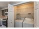 Laundry closet with washer and dryer, wire rack shelving, and plenty of light at 15405 Fawn Meadow Dr, Noblesville, IN 46060