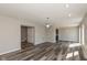 Open-concept living space featuring modern gray flooring, neutral walls, and recessed lighting at 15405 Fawn Meadow Dr, Noblesville, IN 46060