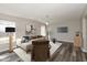 Staged living room with gray flooring, neutral walls, stylish decor, and lots of natural light at 15405 Fawn Meadow Dr, Noblesville, IN 46060