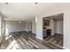 Open-concept living space with modern gray flooring, neutral walls, and a view of the kitchen at 15405 Fawn Meadow Dr, Noblesville, IN 46060