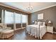 This bedroom features hardwood floors, a metal bed frame, and natural light from the windows at 1591 W 151St St, Westfield, IN 46074