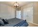 Minimalist bedroom showcasing a modern light fixture and a large closet with white double doors at 1591 W 151St St, Westfield, IN 46074