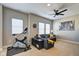 Bonus room with exercise equipment, gray couch, TV and large windows for natural light at 1591 W 151St St, Westfield, IN 46074