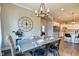 Elegant dining room with a decorative clock, stylish table setting, and direct access to the kitchen at 1591 W 151St St, Westfield, IN 46074