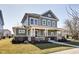 Charming two-story home featuring a large, inviting front porch, well-manicured lawn and appealing curb appeal at 1591 W 151St St, Westfield, IN 46074