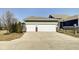 Spacious two-car garage with a wide driveway, complemented by green siding and brick accents on the exterior at 1591 W 151St St, Westfield, IN 46074