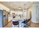Spacious kitchen featuring granite countertops, stainless steel appliances, and a central island with bar seating at 1591 W 151St St, Westfield, IN 46074