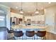 Bright kitchen featuring granite countertops, stainless steel appliances, and a central island with bar seating at 1591 W 151St St, Westfield, IN 46074