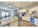 Bright kitchen boasts stainless appliances, granite counters, and white cabinets, blending style with functionality at 1591 W 151St St, Westfield, IN 46074