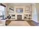 Cozy living room featuring a fireplace, built-in shelves, decorative mirrors, and a contemporary TV at 1591 W 151St St, Westfield, IN 46074