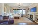 Inviting living room featuring a fireplace, custom built-ins, and abundant natural light from large windows at 1591 W 151St St, Westfield, IN 46074