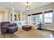 Spacious living room features neutral decor, large windows, and comfortable seating arrangements, perfect for entertaining at 1591 W 151St St, Westfield, IN 46074