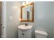 Cozy bathroom featuring a single vanity, framed mirror, and soft light fixtures in a compact design at 1773 Winchester Blvd, Avon, IN 46123