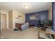 Comfortable bedroom with light carpet, a blue accent wall, and furnishings including a desk, shelves and a bed at 1773 Winchester Blvd, Avon, IN 46123