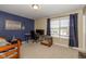 This bedroom features blue accent wall, carpet and a large window providing natural light and ventilation at 1773 Winchester Blvd, Avon, IN 46123