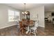 Bright dining room with modern chandelier and view into kitchen and living room at 1773 Winchester Blvd, Avon, IN 46123
