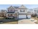 Charming two-story home features a spacious three-car garage, cozy front porch, and brick and siding exterior at 1773 Winchester Blvd, Avon, IN 46123