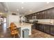 Beautiful kitchen with wooden floor, stainless steel appliances, large island, and dark brown cabinets at 1773 Winchester Blvd, Avon, IN 46123