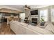 Open living room featuring a fireplace, adjacent to the kitchen with hardwood flooring at 1773 Winchester Blvd, Avon, IN 46123