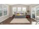 Bright living room with large windows, a comfortable sofa, and access to the outdoors at 1773 Winchester Blvd, Avon, IN 46123