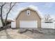 The detached garage provides ample space for parking and storage, with white door and a quaint window above at 2349 S Randolph St, Indianapolis, IN 46203
