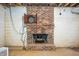 Basement fireplace with brick surround and dart board at 2408 E Stafford Pl, Martinsville, IN 46151