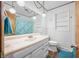 Bright bathroom with vanity, mirror, and shower-tub combo featuring a light blue shower curtain at 2408 E Stafford Pl, Martinsville, IN 46151