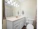 Well-lit bathroom with a single vanity, mirror, and neutral shower curtain, offering comfort and practicality at 2408 E Stafford Pl, Martinsville, IN 46151