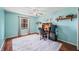 Bedroom featuring wood flooring, ceiling fan, and a built-in desk area at 2408 E Stafford Pl, Martinsville, IN 46151