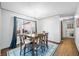 Bright dining room with a wooden table, six chairs, and a large window at 2408 E Stafford Pl, Martinsville, IN 46151