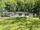 Charming brick home features a lush lawn, flowerbeds, and a convenient attached garage at 2408 E Stafford Pl, Martinsville, IN 46151