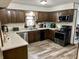 Well-equipped kitchen with stainless steel appliances, dark wood cabinets, and durable countertops at 2408 E Stafford Pl, Martinsville, IN 46151