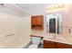A clean, well-lit bathroom featuring a vanity with a sink, toilet, shower-tub combo, and a wooden cabinet at 245 Suncrest Dr, Greenwood, IN 46143