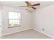 Bright bedroom with carpet and neutral walls, featuring a ceiling fan and natural light from a window at 245 Suncrest Dr, Greenwood, IN 46143