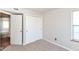 A simple bedroom includes carpeted floors, neutral walls, a closet, and a window providing ample natural light at 245 Suncrest Dr, Greenwood, IN 46143